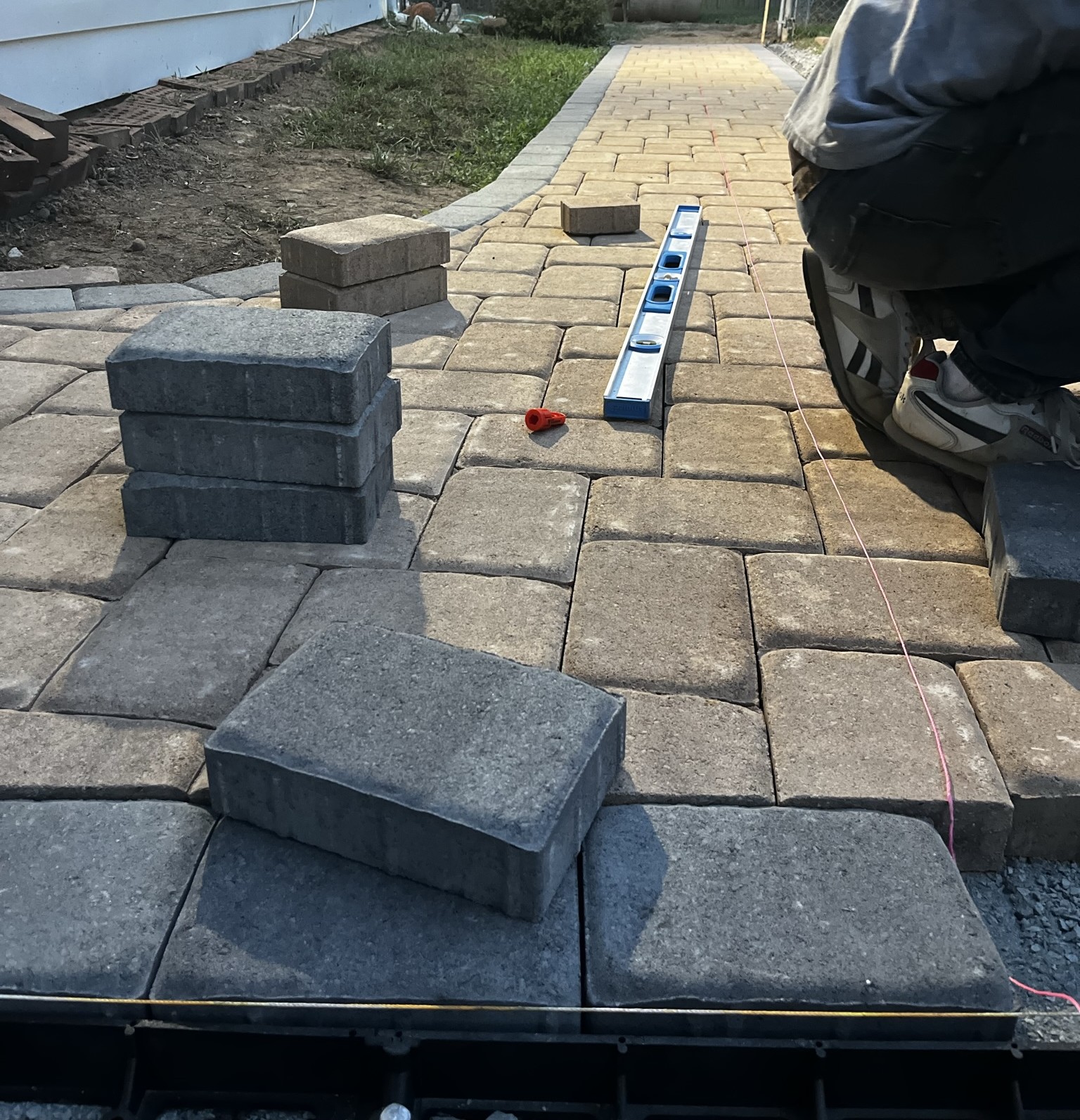 Paver walkway being carefully installed